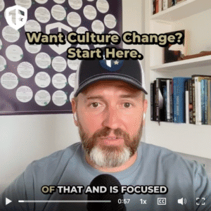 Coach Brandon Jenkins discusses leadership and climate. He is pictured in a Tier One baseball hat with a blueprint behind him.